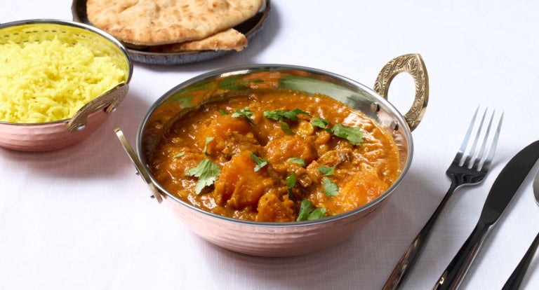 mutton dhansak dish served with rice and naan