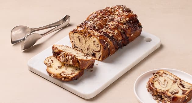 Sliced loaf with topping on board.