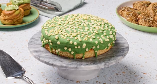 Green‑iced cake with white sprinkles.