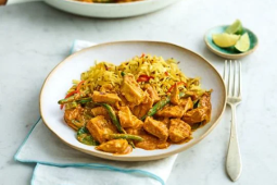 vegan curry served in a dish with slices of lemon