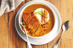 katsu curry dish with breaded fillet on a plate