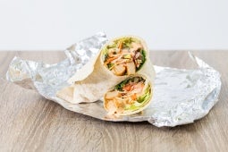 bang bang veggie wrap placed on foil on a table