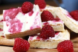 milkybar traybake with raspberries on a table