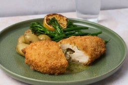 truffle chicken kiev dish plated with broccoli and new potatoes