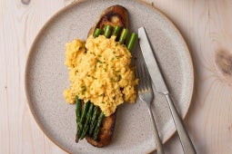 plated scrambled eggs with asparagus on sourdough with maggi truffle seasoning