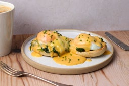 plated eggs royal with truffle hollandaise sauce garnished with chives