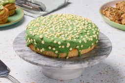 Green‑iced cake with white sprinkles.