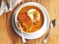 katsu curry dish with breaded fillet on a plate