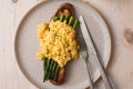 plated scrambled eggs with asparagus on sourdough with maggi truffle seasoning