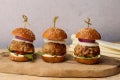 three truffle turkey meatball sliders plated with skewers