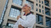 woman smiling outside an office building