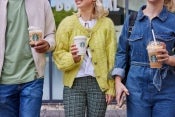 People carrying hot and iced Starbucks drinks