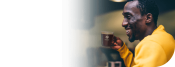 young man smiling and drinking NESCAFE