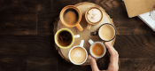 six different Nescafé workplace coffee cups displayed in a circle