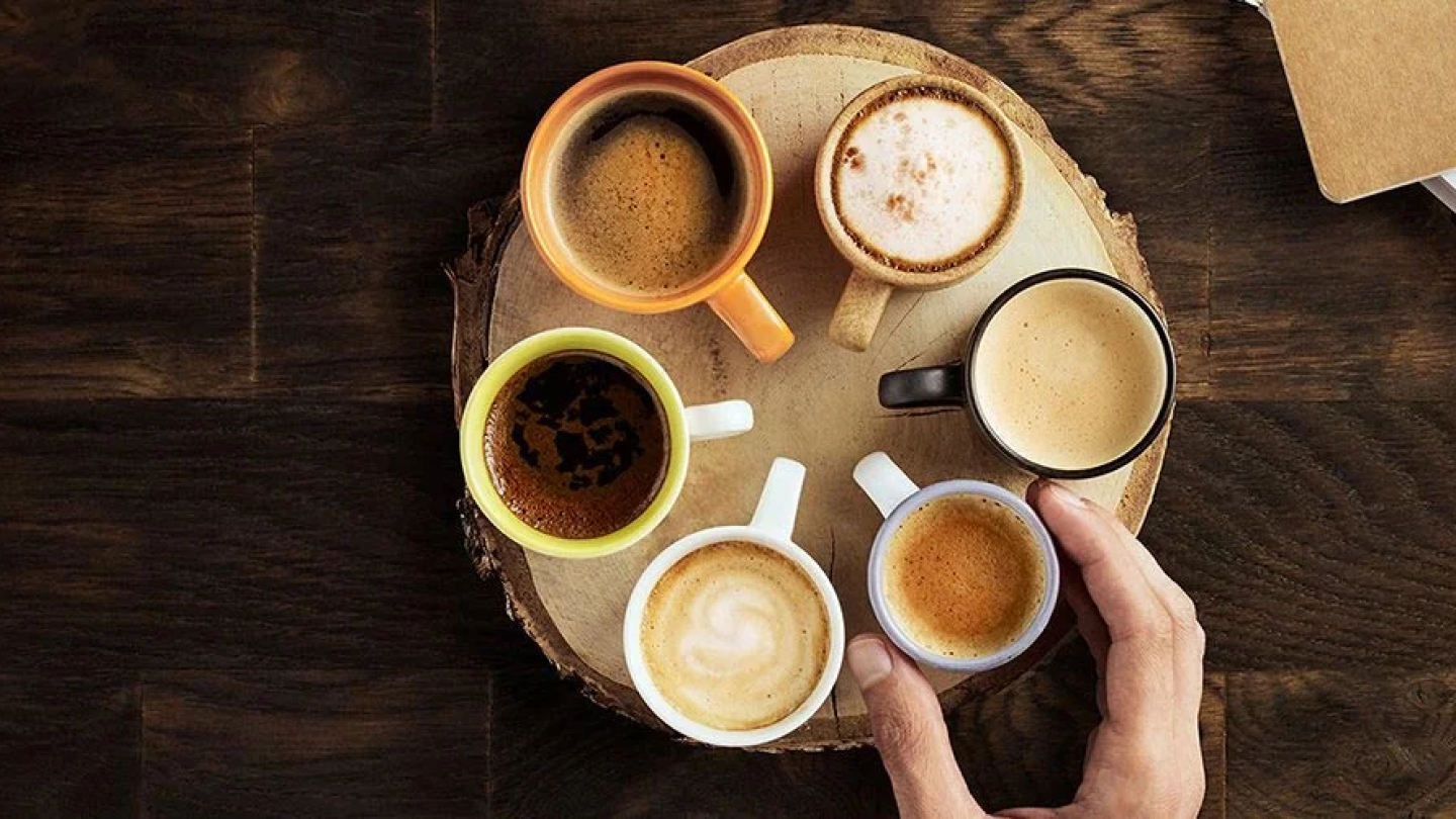 six different Nescafé workplace coffee cups displayed in a circle