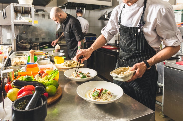 Chefs working in a dark kitchen