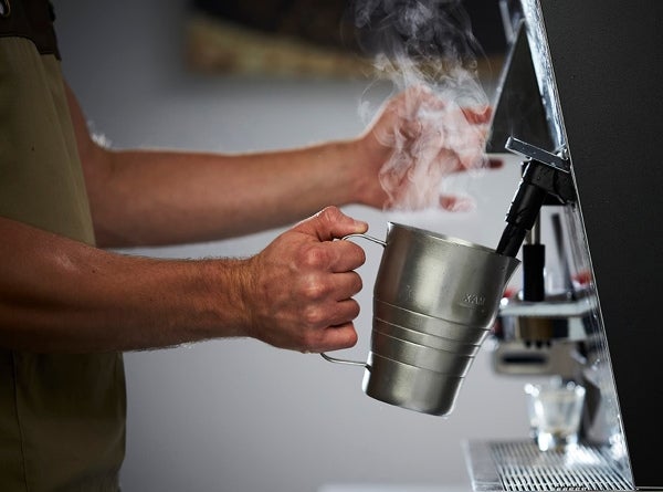 barista hands steaming milk